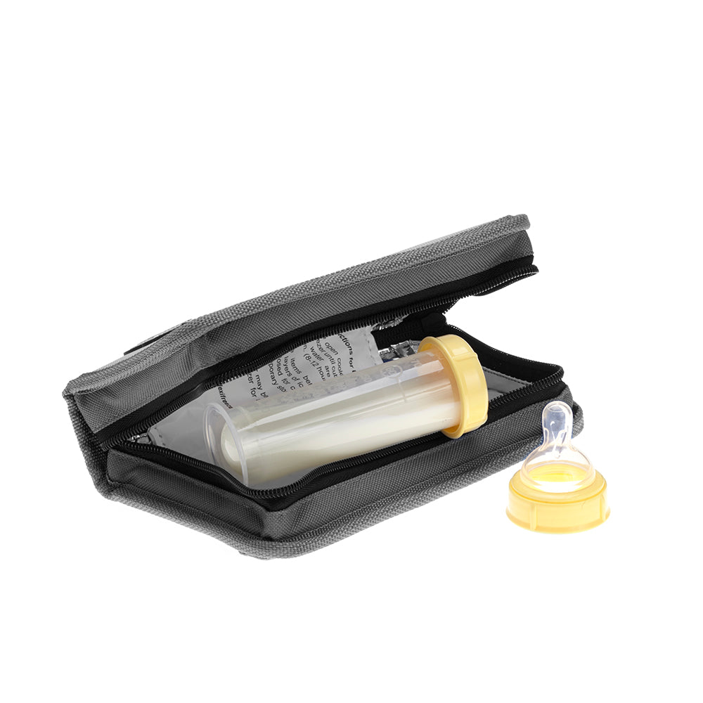 FlexiFreeze refreezable breastmilk pocketbook cooler, charcoal,  laying open on its side with a container of milk inside