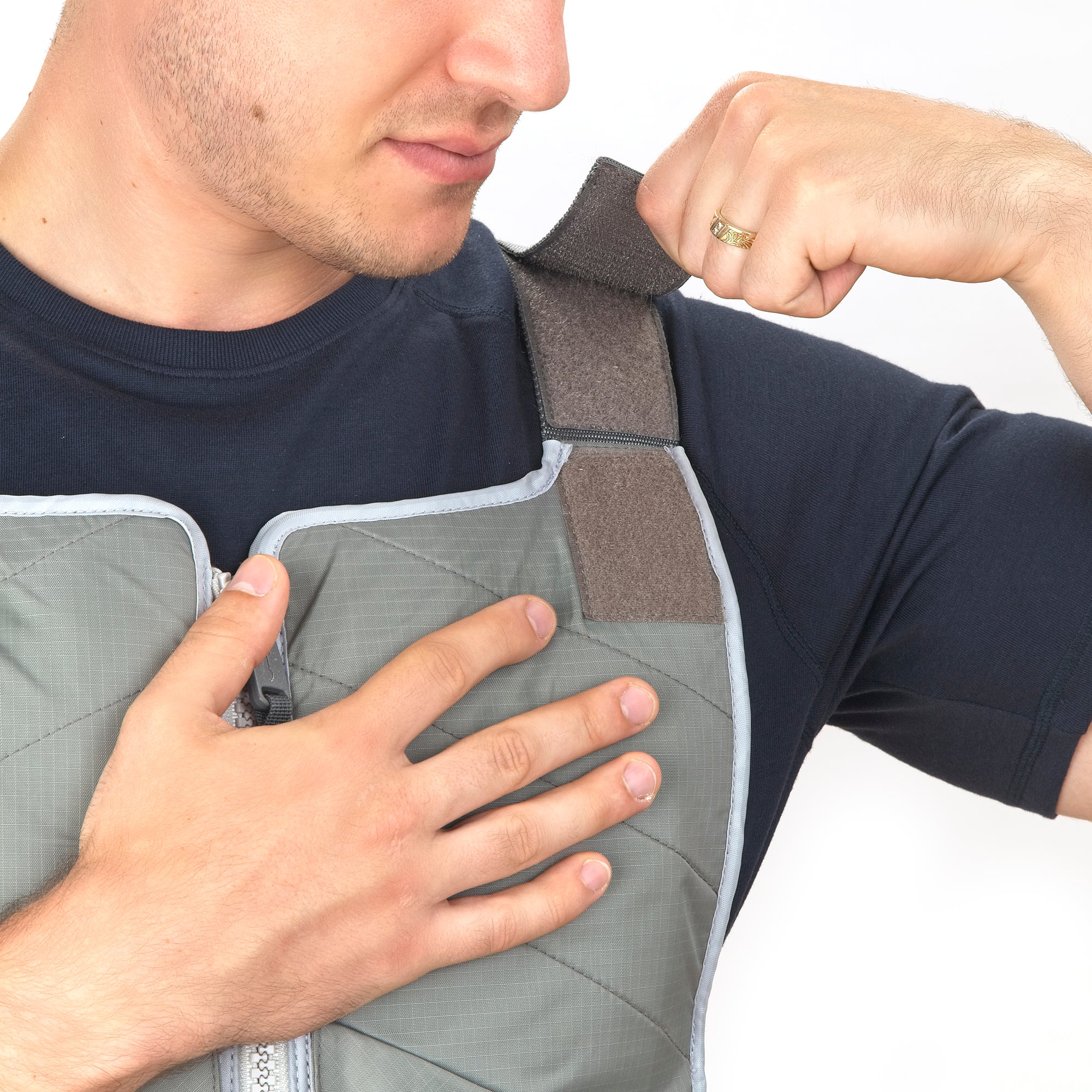 Man wearing FlexiFreeze professional ice vest, adjusting shoulder strap, charcoal