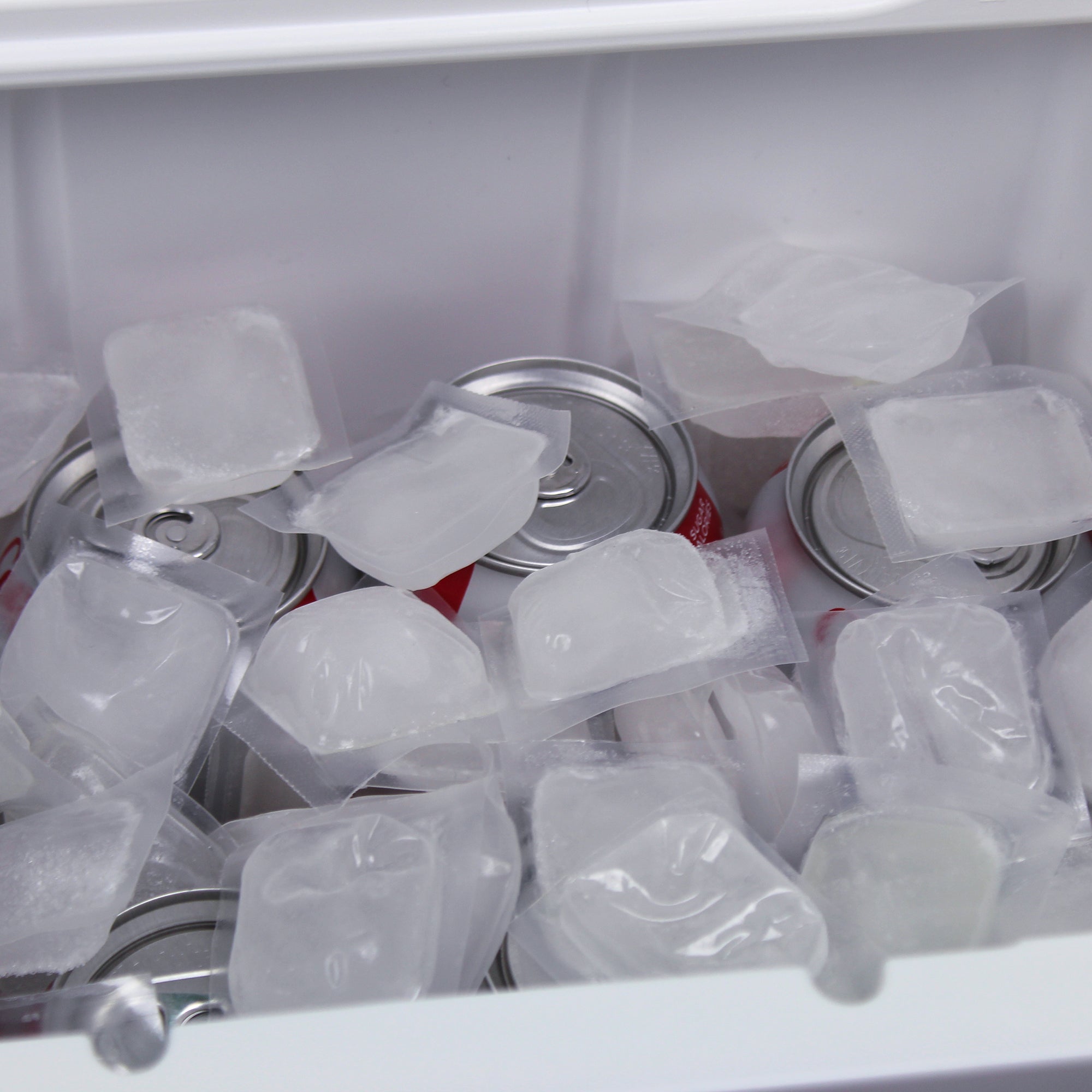 Close up of open cooler of soda, filled with individual refreezable FlexiFreeze cooler cubes