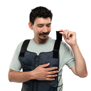 Man wearing FlexiFreeze professional ice vest, adjusting shoulder strap, navy